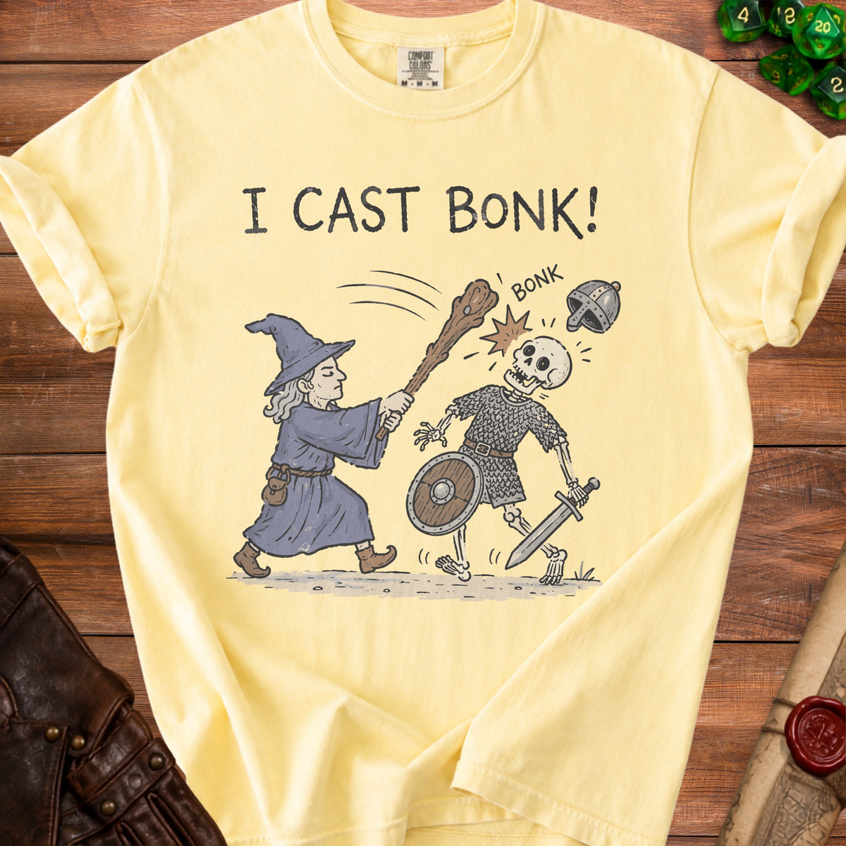 Yellow t-shirt with "I CAST BONK!" text and wizard fighting a skeleton.