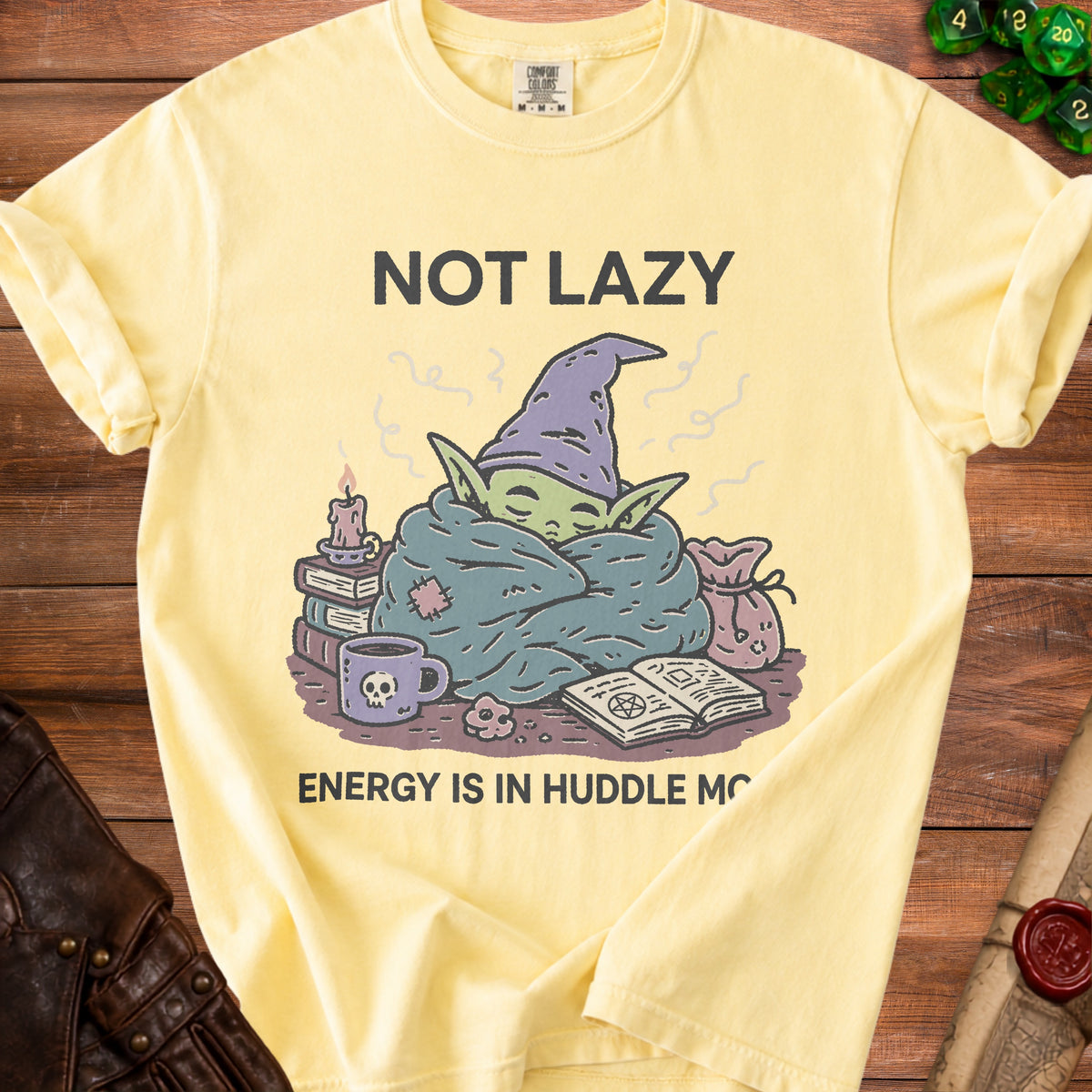 Yellow t-shirt with "Not Lazy Energy is in Huddle Mo" and a cozy creature graphic.