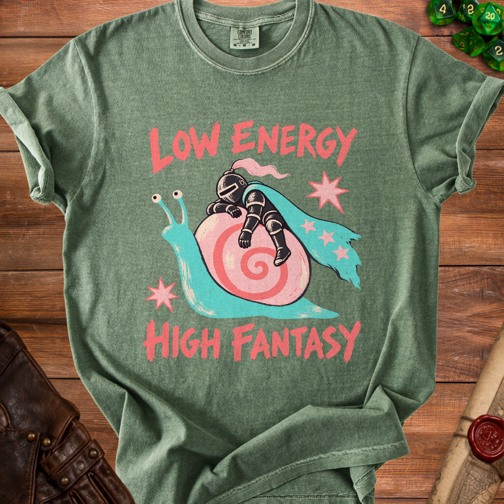 Olive green t-shirt with a graphic of a knight riding a snail, reading Low Energy High Fantasy.