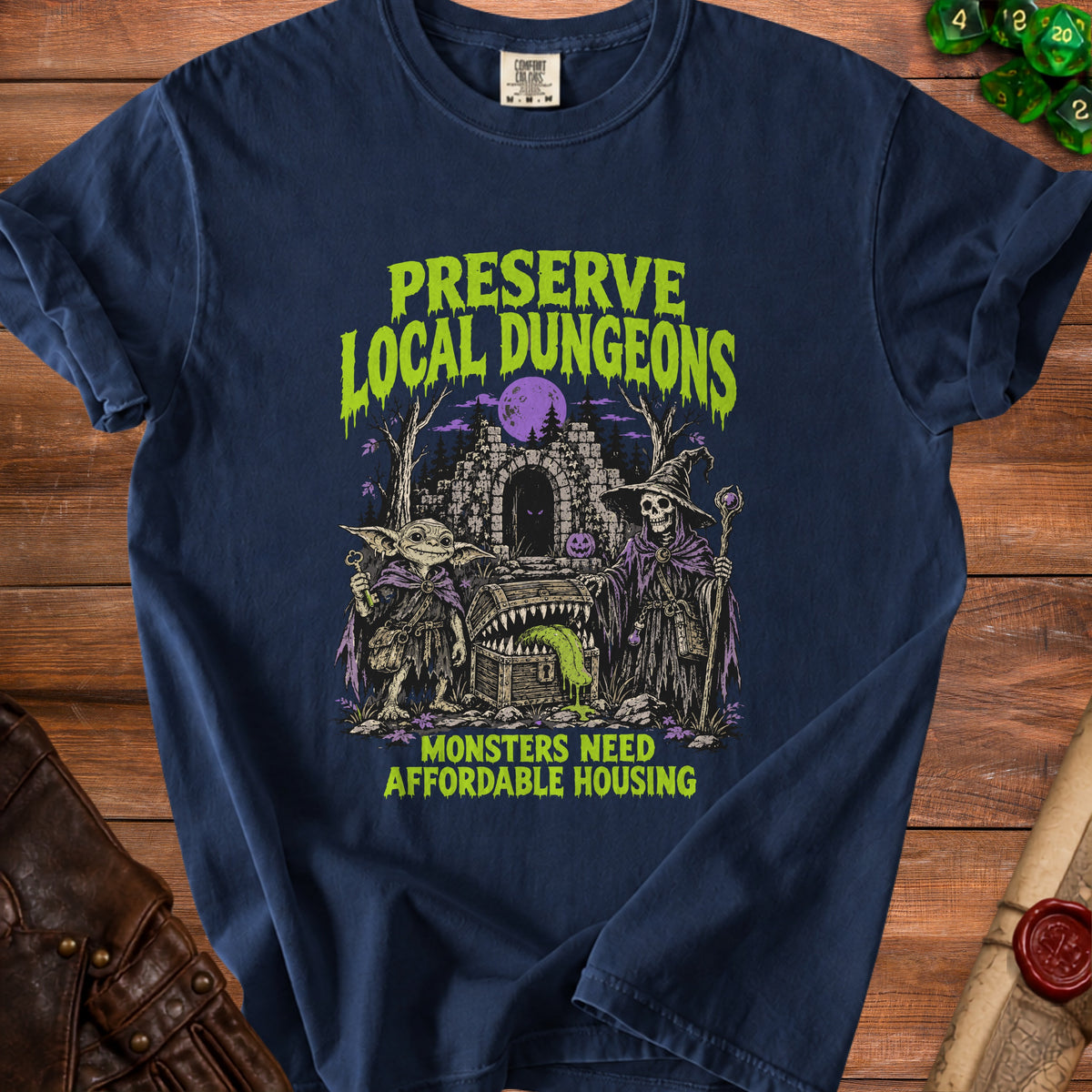 Dark blue t-shirt with "Preserve Local Dungeons" and "Monsters Need Affordable Housing" text and artwork.