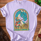 Light purple t-shirt with a cartoon of a lute-playing bard facing a dragon and text saying "Diplomacy is going well."