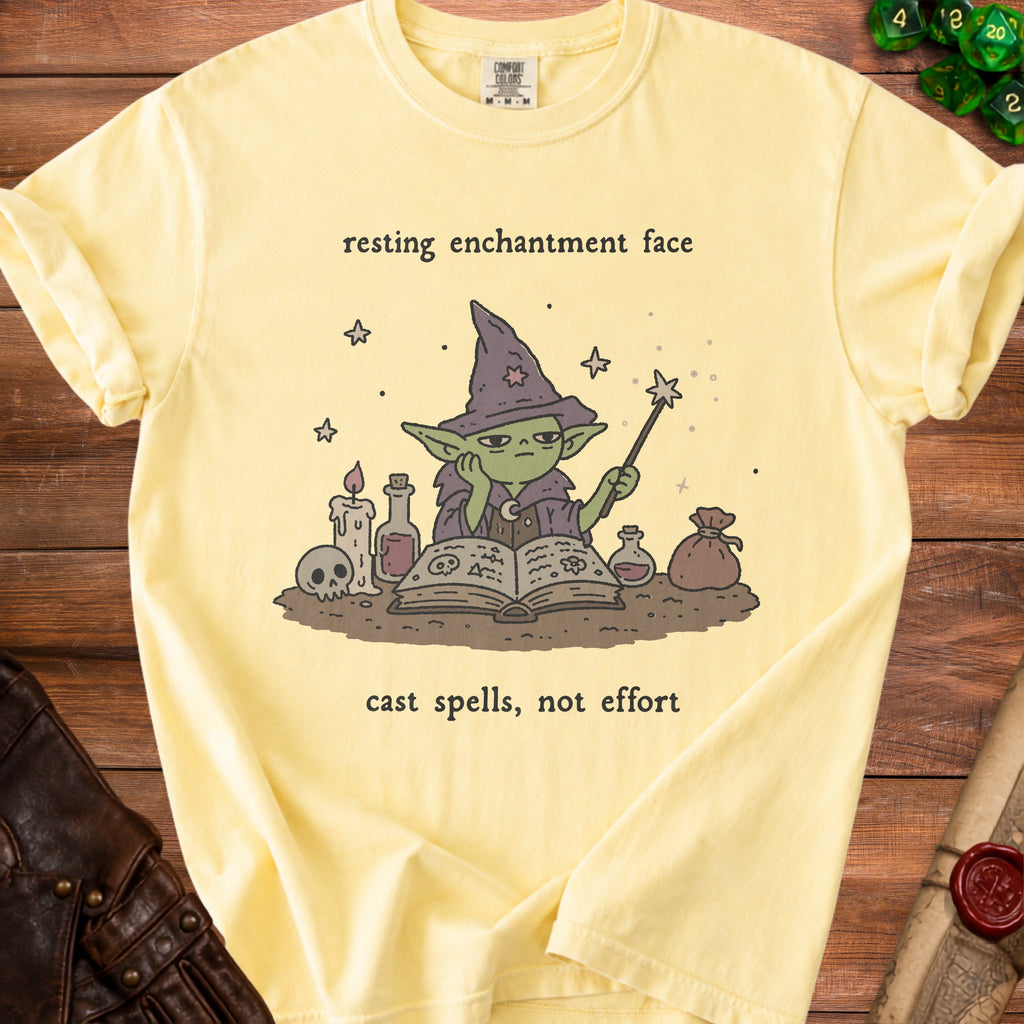 Yellow t-shirt with a wizard graphic and text "resting enchantment face cast spells, not effort."
