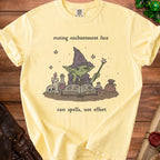 Yellow t-shirt with a wizard graphic and text "resting enchantment face cast spells, not effort."