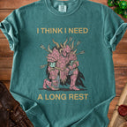 Teal t-shirt with gold text "I THINK I NEED A LONG REST" and pink knight graphic.