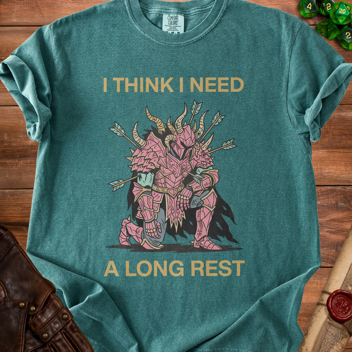 Teal t-shirt with gold text "I THINK I NEED A LONG REST" and pink knight graphic.