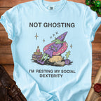 Light blue t-shirt with a goblin wizard sleeping on a mushroom and text "Not Ghosting, I'm Resting My Social Dexterity".