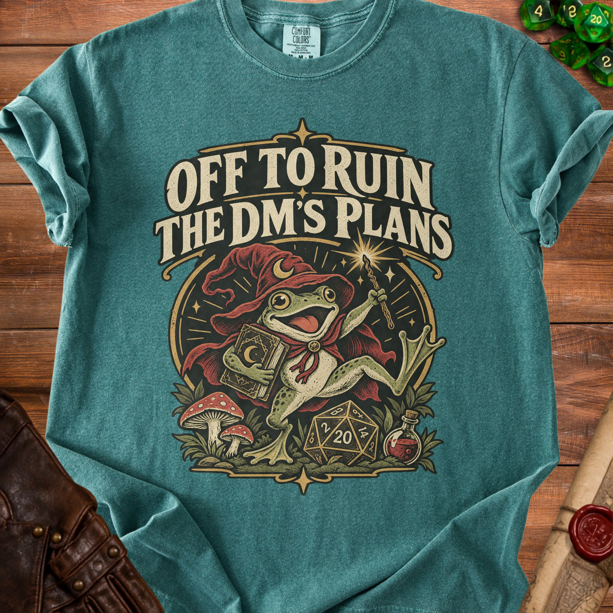 Teal t-shirt with frog wizard graphic and text "OFF TO RUIN THE DM'S PLANS".