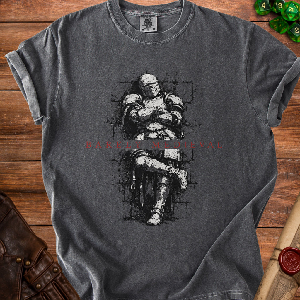 Dark grey t-shirt with a black and white illustration of a knight sitting.