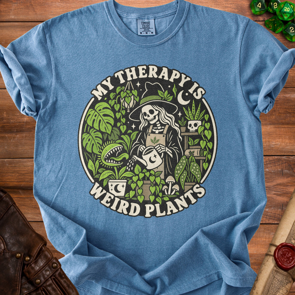 Blue t-shirt with skeleton watering plants and text "My Therapy Is Weird Plants".