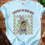 Light blue t-shirt with a cartoon goblin screaming and text that reads "EVERYDAY MY HEAD GOES AAAAA".