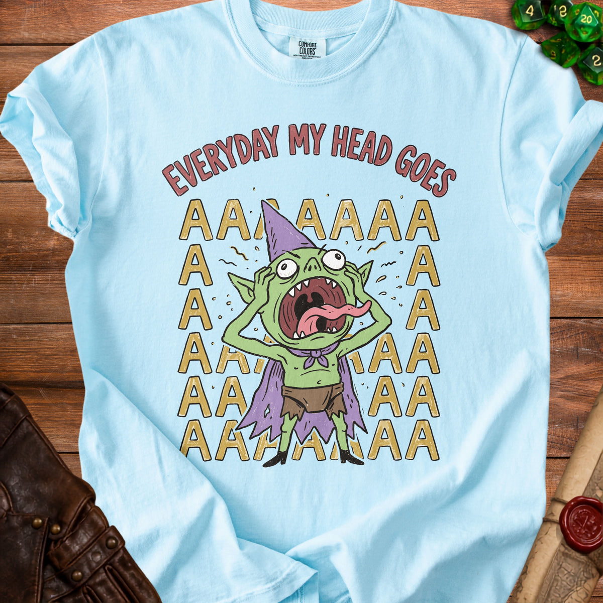 Light blue t-shirt with a cartoon goblin screaming and text that reads "EVERYDAY MY HEAD GOES AAAAA".