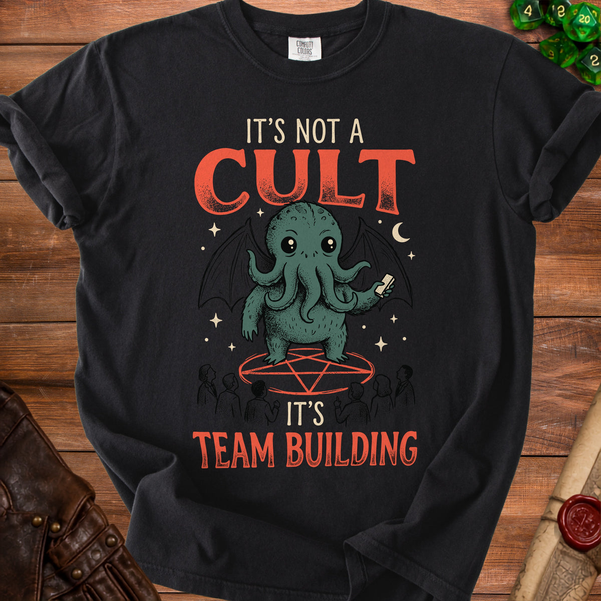 Black t-shirt with a graphic of a tentacled creature and text "IT'S NOT A CULT IT'S TEAM BUILDING".