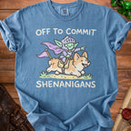 Blue t-shirt with cartoon knight goblin riding a corgi, says "Off to commit shenanigans".