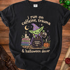 Black t-shirt with a goblin wizard pouring coffee into a cauldron that says "Good Vibes".