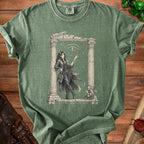 Green t-shirt with illustration of a devilish woman and text "MY PATRON EXPECTS TOO MUCH".
