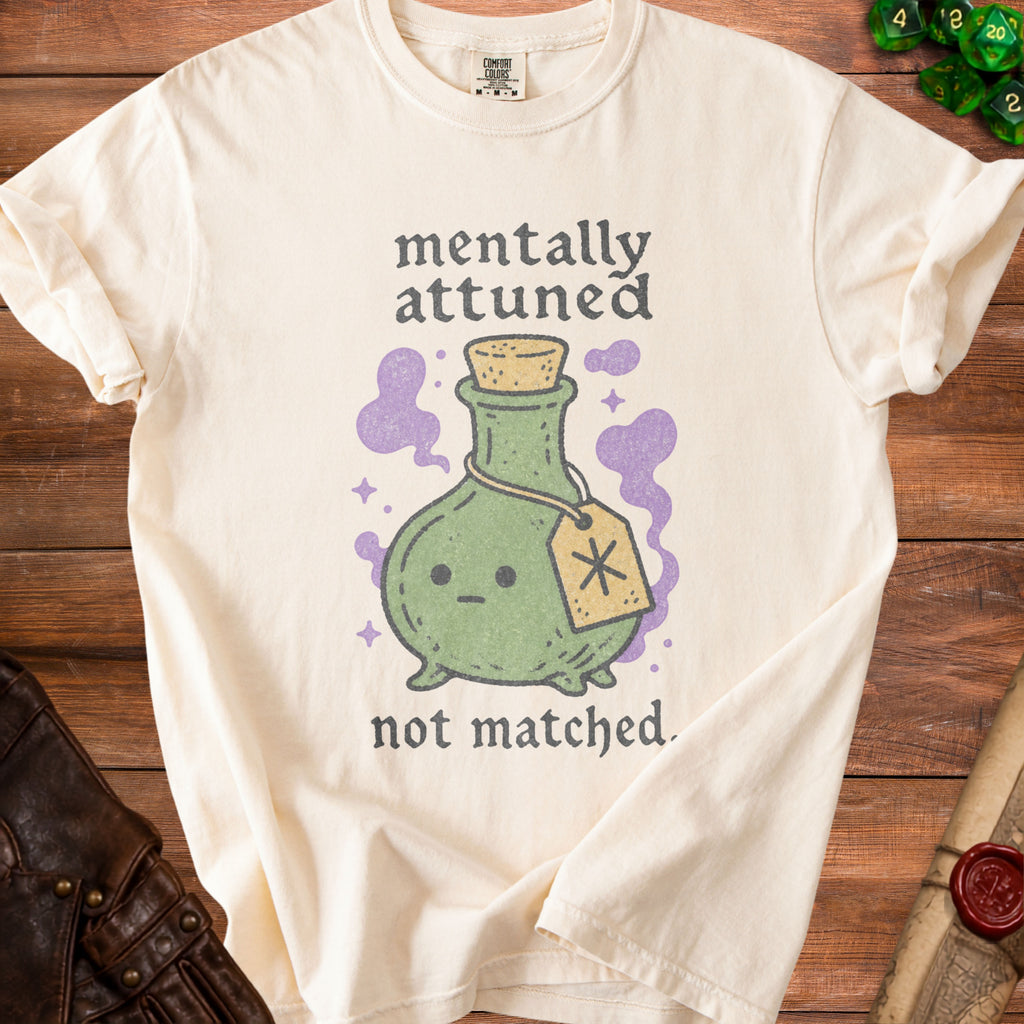 Cream t-shirt with "mentally attuned not matched" text and cartoon potion bottle.