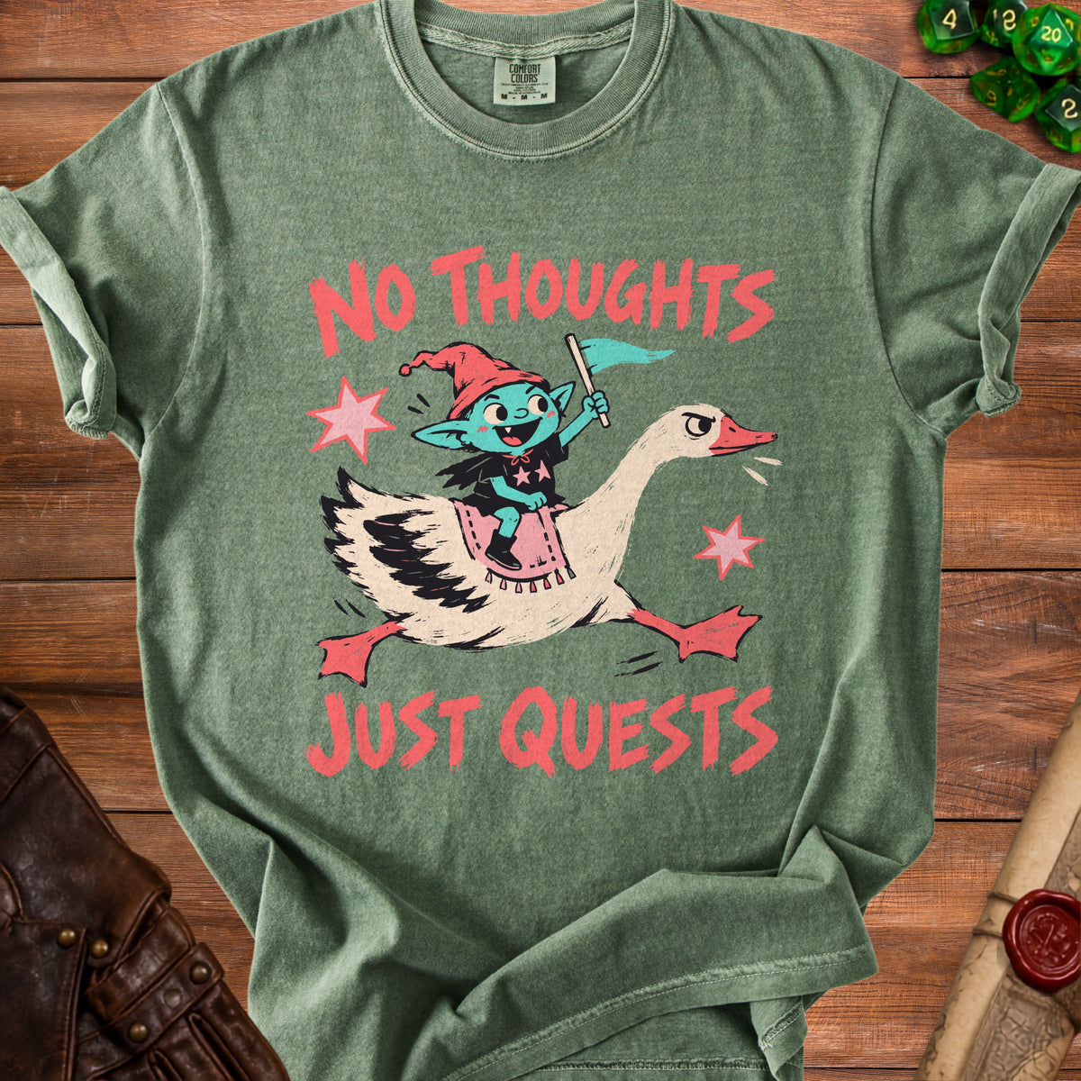 Green t-shirt with elf riding goose, "No Thoughts Just Quests" text.