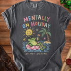 Dark gray t-shirt with a frog on an inner tube, text "MENTALLY ON HOLIDAY", and "DO NOT DISTURB".
