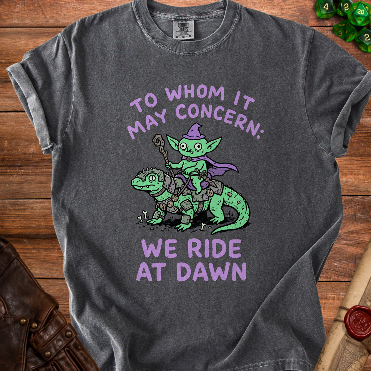 Dark grey t-shirt with purple text and goblin riding a lizard graphic.