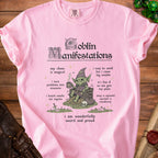 Pink t-shirt with "Goblin Manifestations" graphic, featuring a goblin and descriptive text.