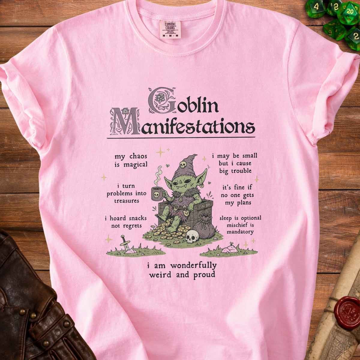 Pink t-shirt with "Goblin Manifestations" graphic, featuring a goblin and descriptive text.