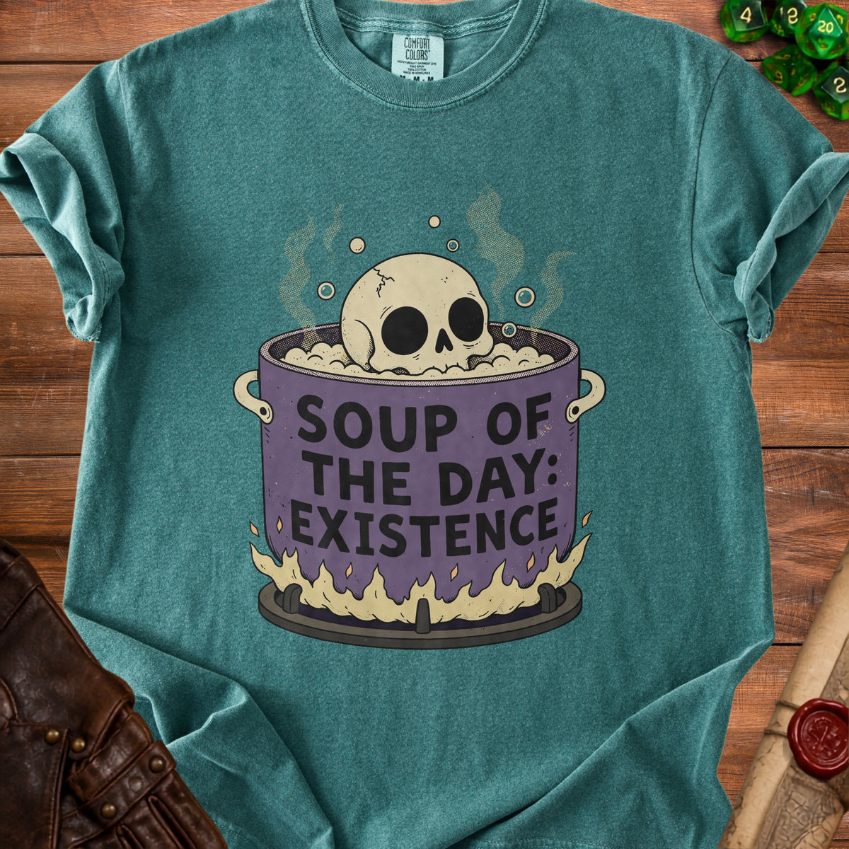 Teal t-shirt with a skull in a pot that says "Soup of the Day: Existence".