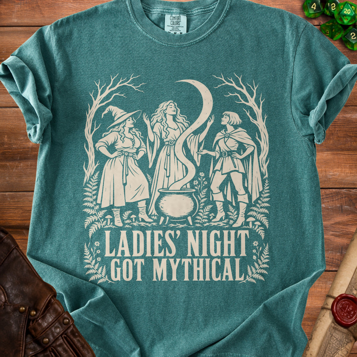 Three women are depicted around a cauldron with the text "LADIES' NIGHT GOT MYTHICAL".