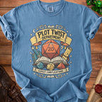 Blue t-shirt with "Plot Twist Department Expect Complications" and dice graphic.