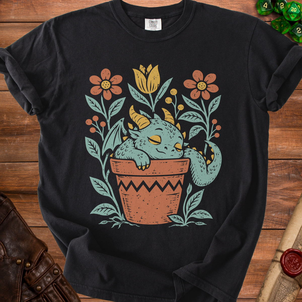 Black t-shirt with sleeping dragon in a flower pot graphic.