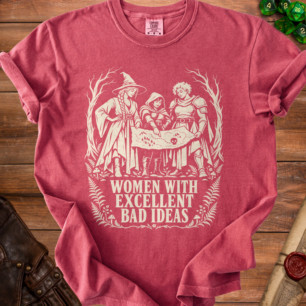 Crimson t-shirt with three women looking at a map, "Women With Excellent Bad Ideas" text.
