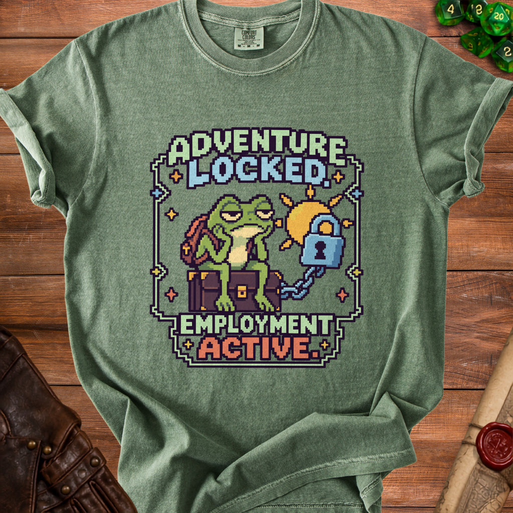 Green crewneck t-shirt featuring pixel art of a frog sitting on a trunk and the text ADVENTURE LOCKED EMPLOYMENT ACTIVE.