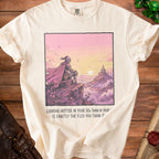 T-shirt with knight looking at castle, text reads "Looking hotter in your 30s than in your ... is exactly the flex you think it".