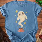 Blue t-shirt with a watercolor ghost holding a steaming coffee cup and yellow stars.