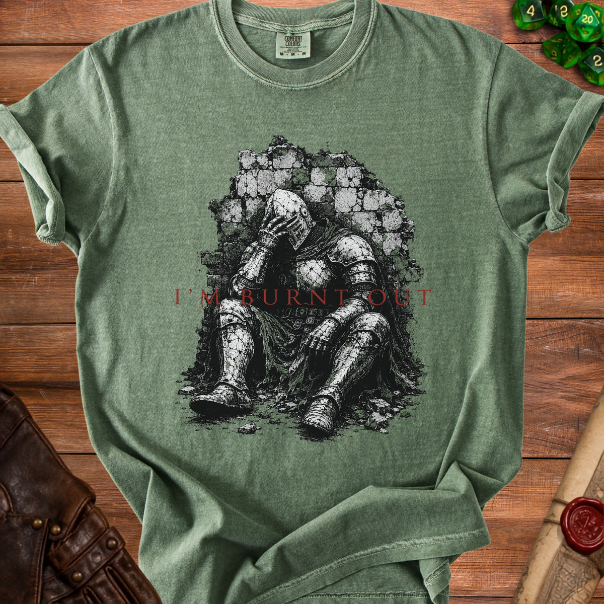 Green t-shirt with graphic of knight sitting against brick wall, text says "I'm Burnt Out".