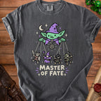 Dark gray t-shirt with "Master of Fate" text and a goblin puppet master with fantasy characters.