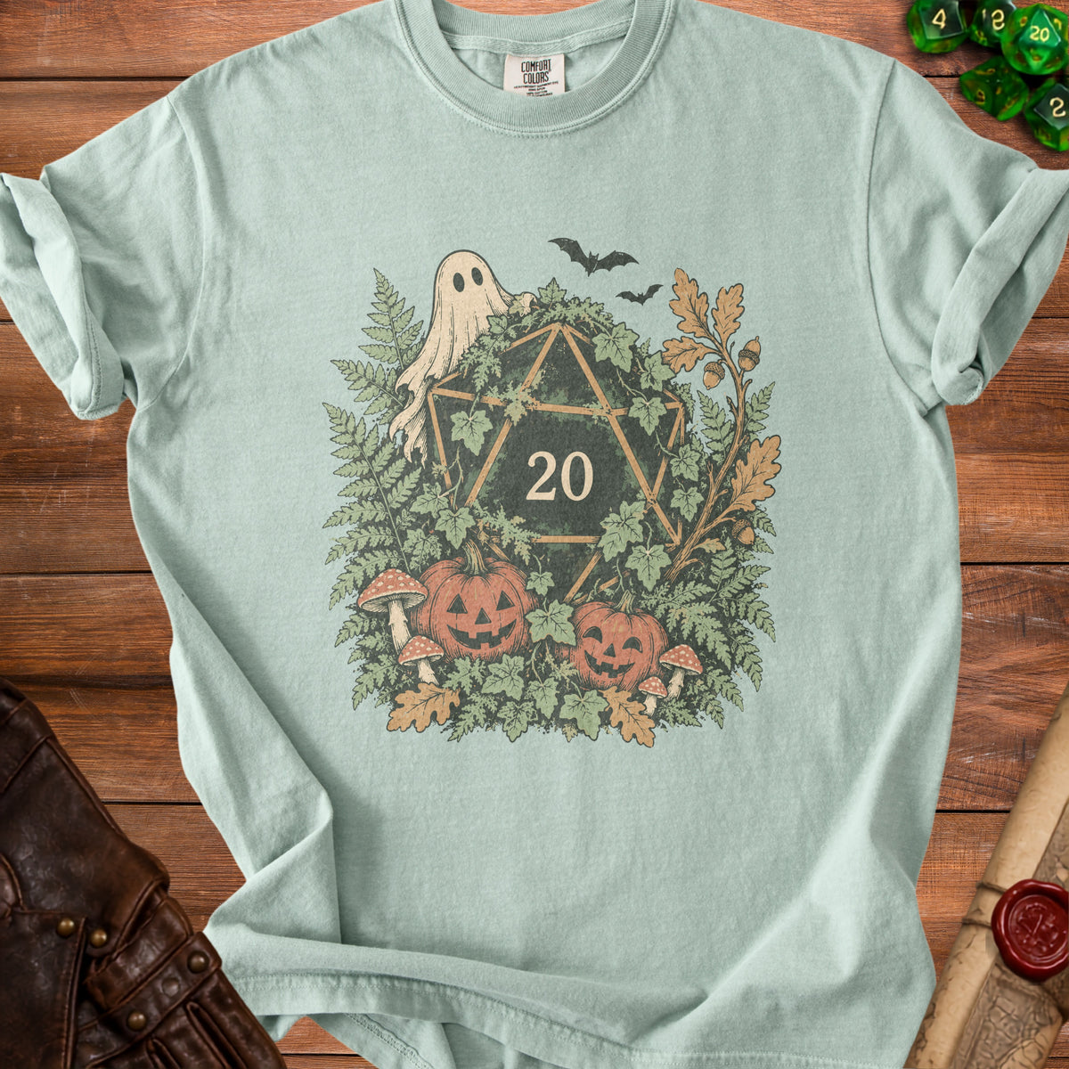 Green t-shirt with a D20 die surrounded by Halloween-themed nature elements.