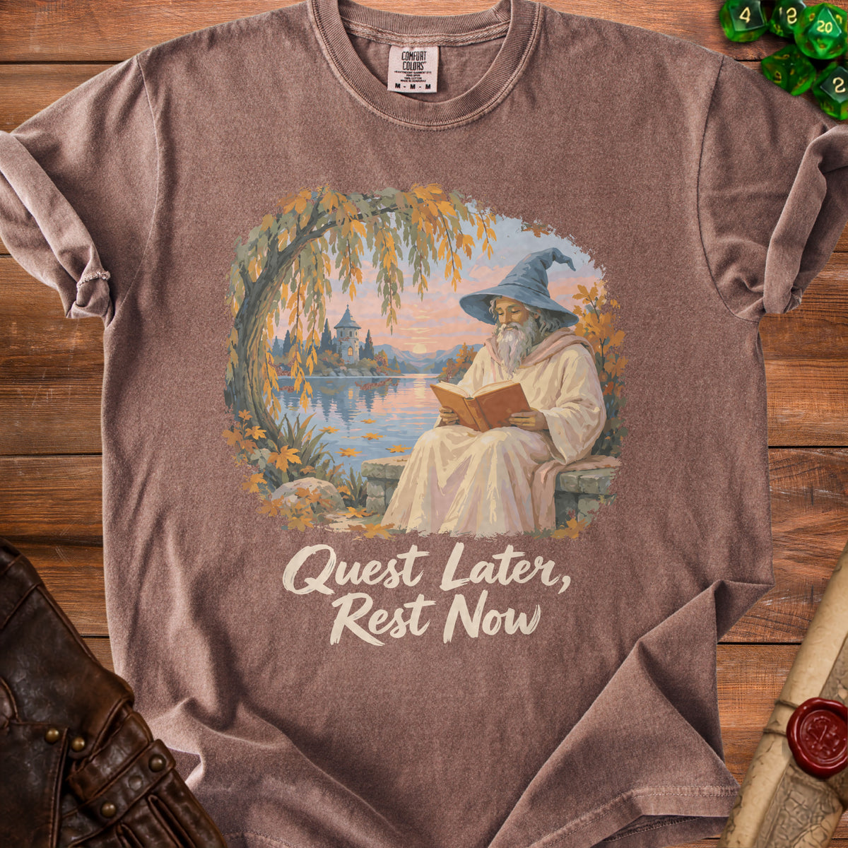 T-shirt with wizard reading by lake and text "Quest Later, Rest Now".