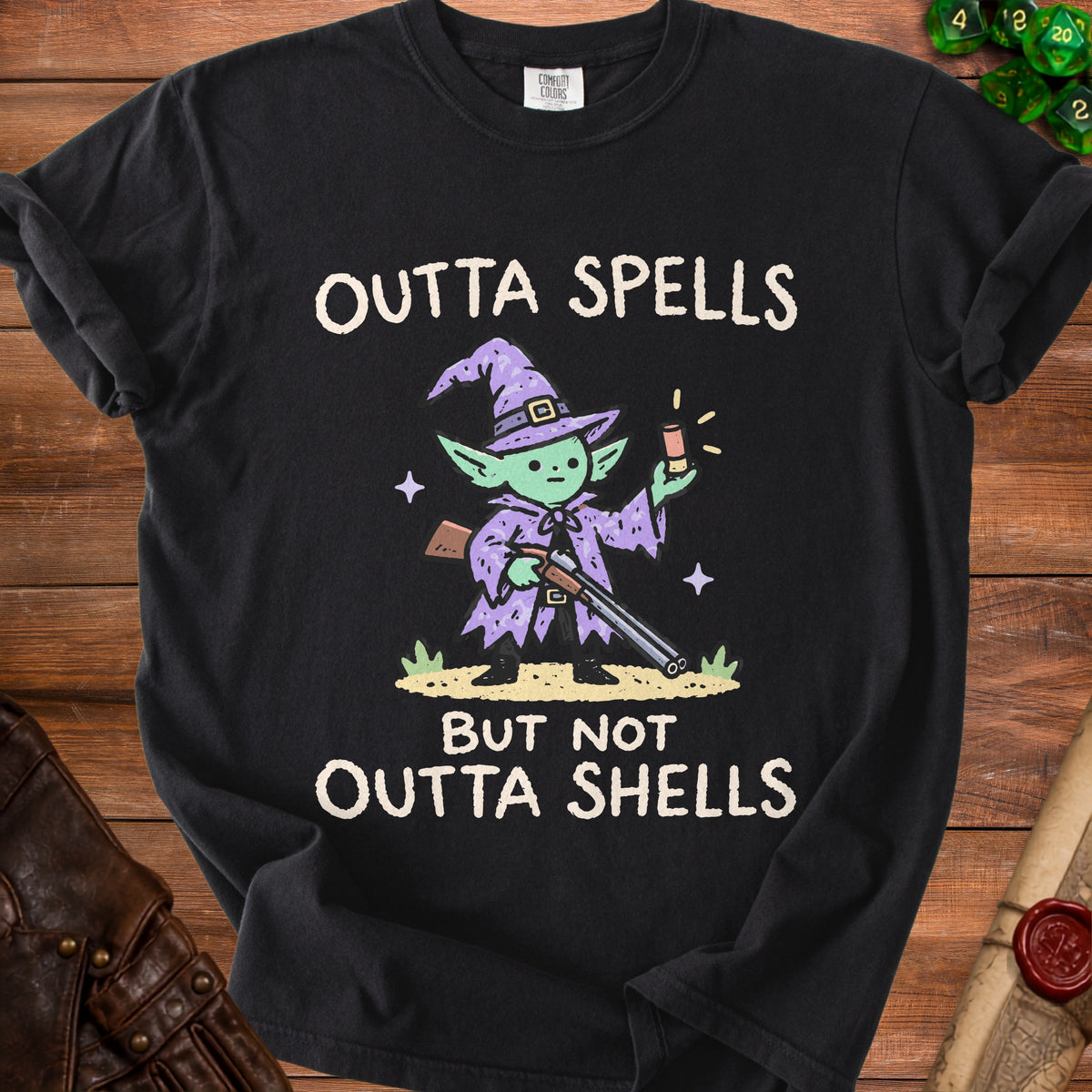 Black t-shirt with wizard creature holding shotgun and text "OUTTA SPELLS BUT NOT OUTTA SHELLS".