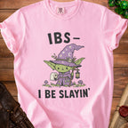 Pink t-shirt with a cartoon witch holding toilet paper and the text "IBS- I BE SLAYIN'".