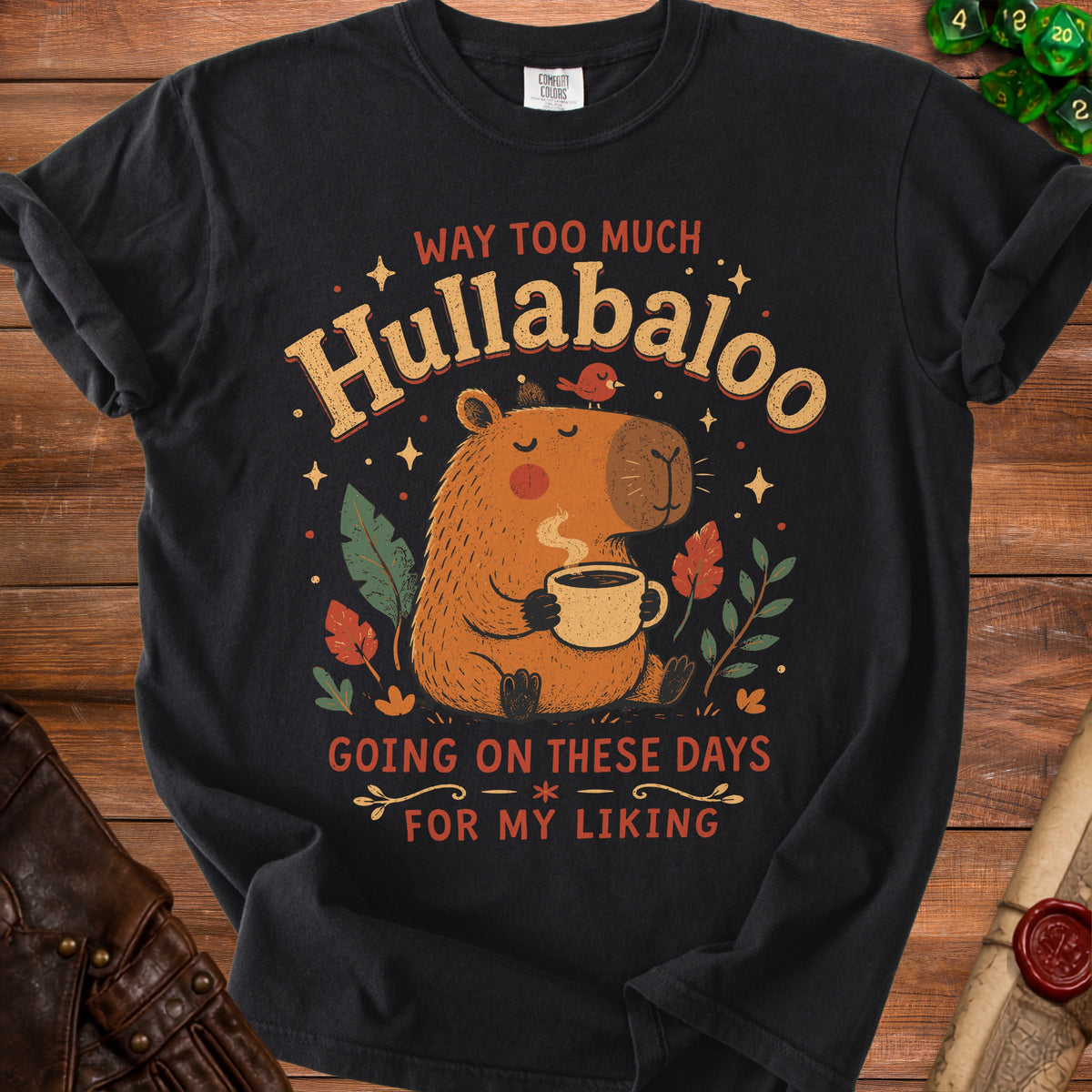 Black t-shirt with capybara graphic and text "Way Too Much Hullabaloo Going On These Days For My Liking".