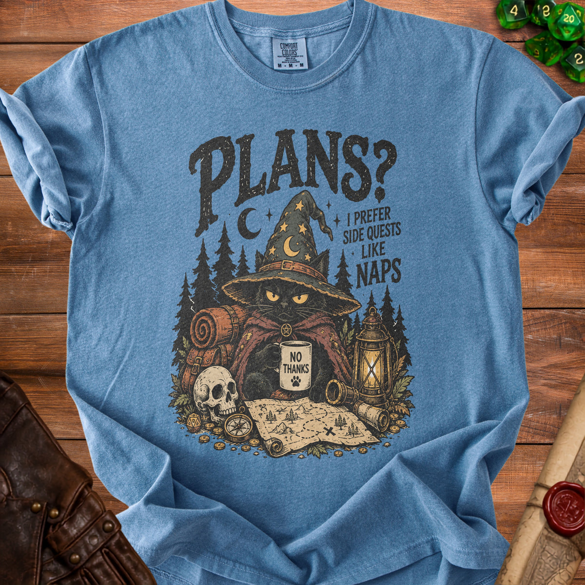 Blue t-shirt with black graphic of cat wizard, map, and text "Plans? I prefer side quests like naps".