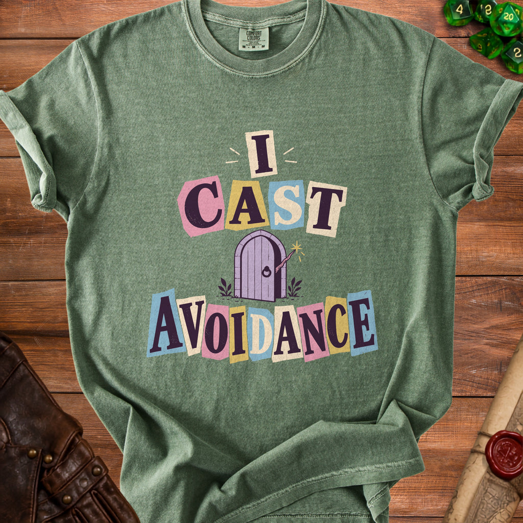 Green t-shirt with "I CAST AVOIDANCE" text and a purple door illustration.
