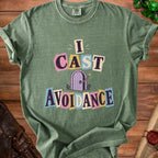 Green t-shirt with "I CAST AVOIDANCE" text and a purple door illustration.