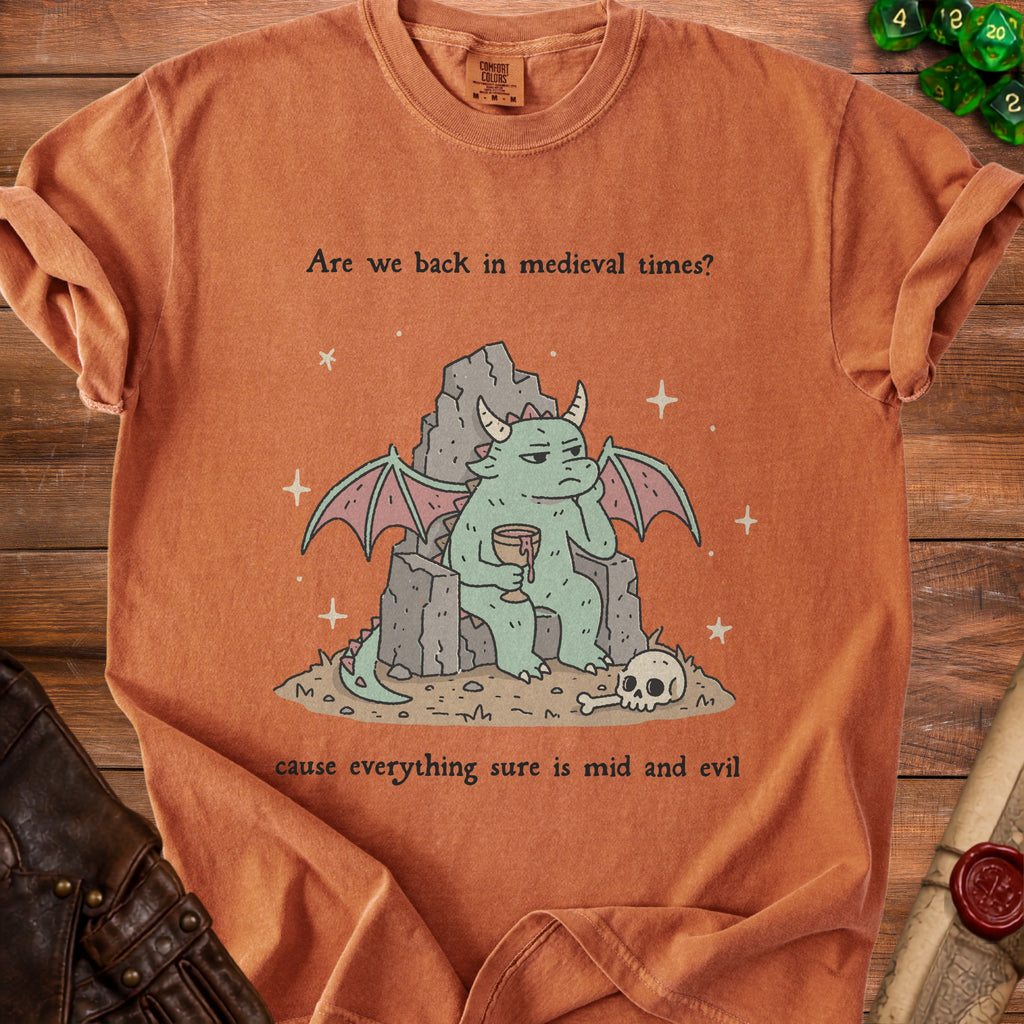 Orange t-shirt with a dragon sitting on rocks, holding a goblet, and text.
