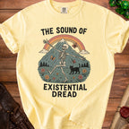 T-shirt with skeleton, black cat, mountains, rainbow, and text "THE SOUND OF EXISTENTIAL DREAD".