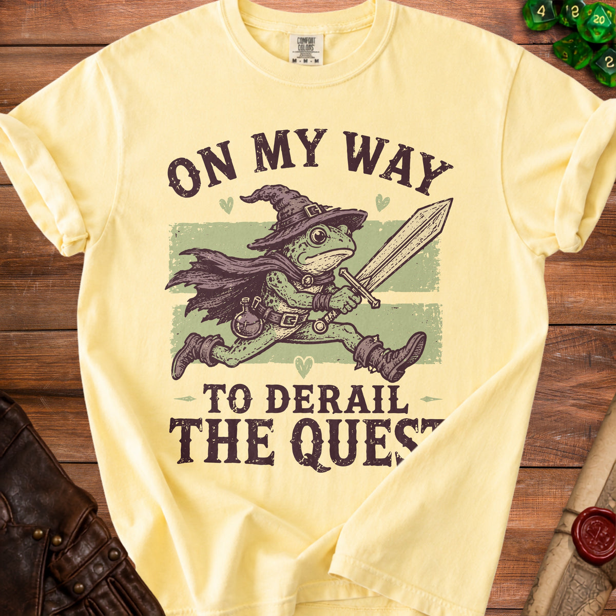 Yellow t-shirt with text "On my way to derail the quest" and a frog warrior graphic.