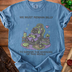 Blue t-shirt with a black cat gamer graphic and text "WE MUST REMAIN SILLY TO SURVIVE THE HORRORS OF THIS WORLD".