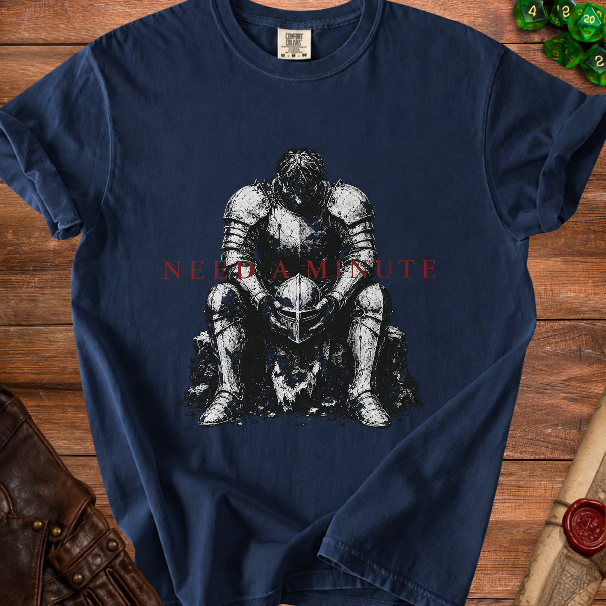 Dark blue t-shirt with distressed knight sitting, holding helmet, text "NEED A MINUTE".
