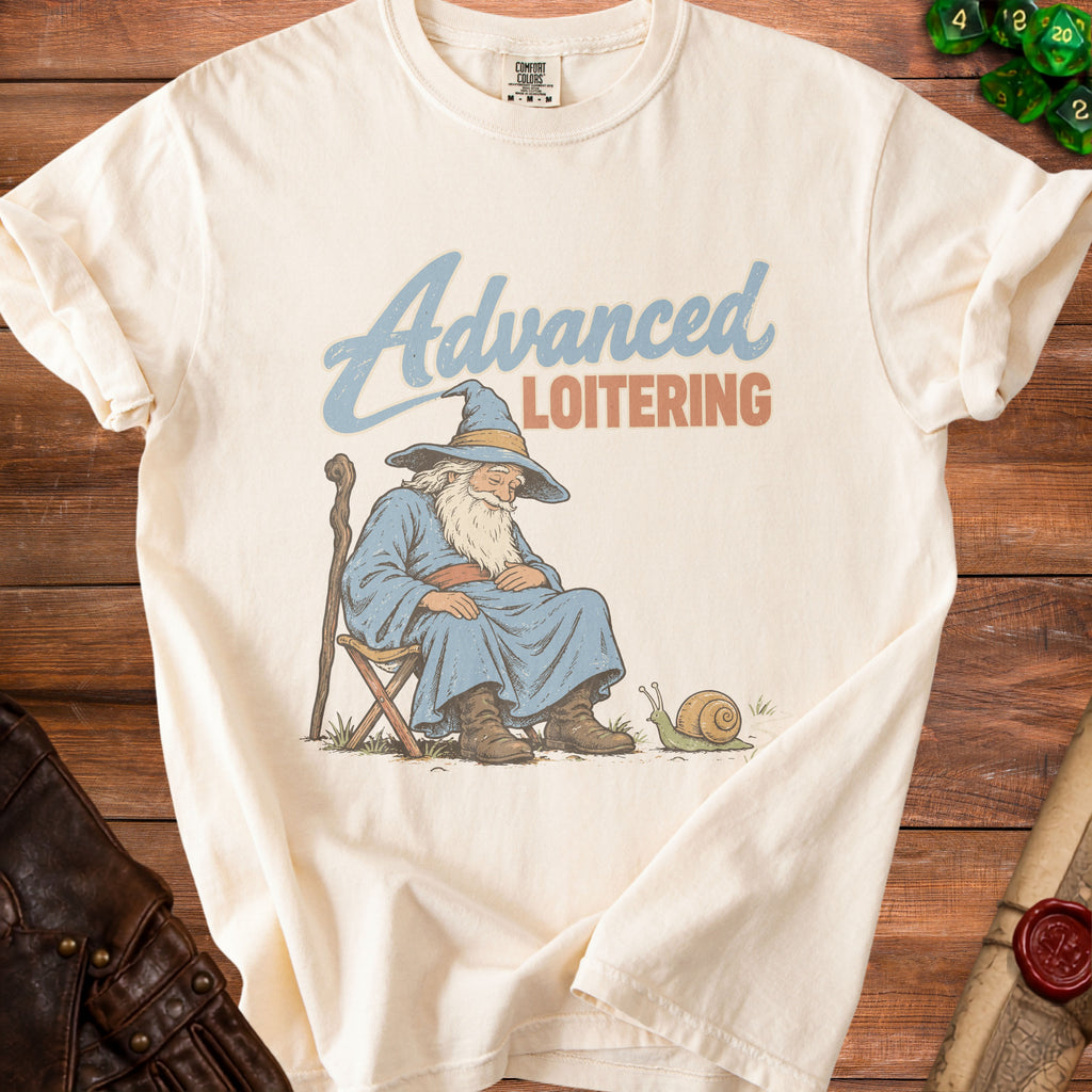 Off-white t-shirt featuring a graphic of a sleeping wizard with a snail and the text Advanced Loitering.