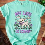 Mint green t-shirt with a cartoon lamb and text "MY LIFE IS CRAP".